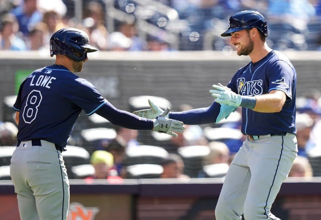 Tampa Bay Rays designated hitter Josh Lowe (15) celebrates his solo home run with teammate Brandon Lowe (8) during the fifth inning of a baseball game against the Tampa Bay Rays in Toronto, Thursday, May 15, 2025. (Nathan Denette/The Canadian Press via AP)