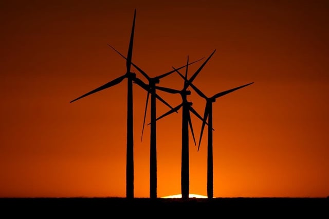 Wind turbines are silhouetted against the setting sun at the Spearville Wind Farm, Sunday, Sept. 29, 2024, near Spearville, Kan. 