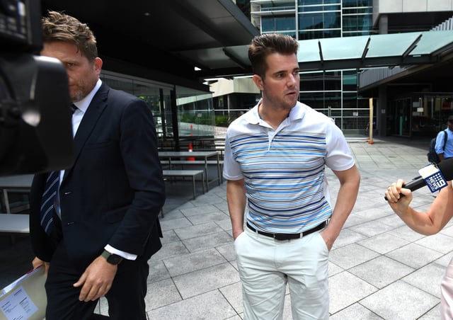 Eric Thomas (right) is seen leaving the Brisbane Magistrates Court in Brisbane, Wednesday, March 9, 2022. Eric Thomas, who was previously known as Gable Tostee, pleaded guilty to failing to supply a breath and blood specimen after a crash on October 13. He was naked when found trapped in his car on the Gold Coast. (AAP Image/Darren England) NO ARCHIVING