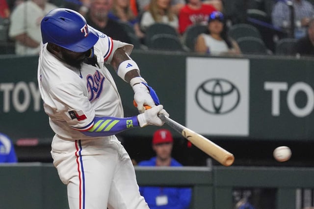 Texas Rangers&#39; Adolis García hits a double during the fifth inning of a baseball game against the Houston Astros, Thursday, May 15, 2025, in Arlington, Texas. (AP Photo/LM Otero)