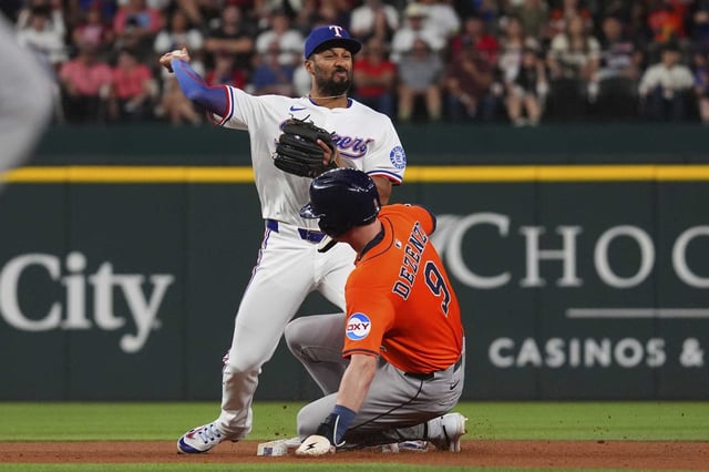 Texas Rangers second baseman Marcus Semien, left, throws on a force out at second against a sliding Houston Astros&#39; Zach Dezenzo (9) allowing Jake Meyers to reach fist base safely during the seventh inning of a baseball game, Thursday, May 15, 2025, in Arlington, Texas. (AP Photo/LM Otero)