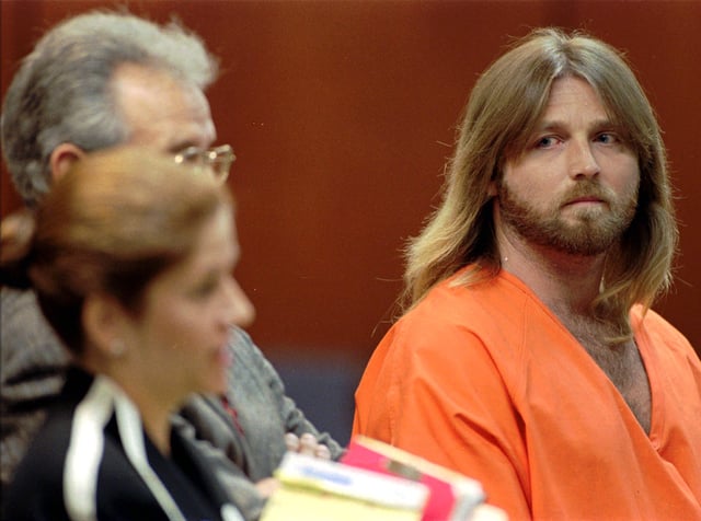 In this July 8, 1996 file photo, convicted murderer Glen Rogers, right, stares at Public Defender Joan Corces during a hearing in Tampa, Florida.
