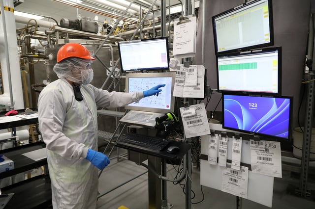 A person touches a display as food aid is made and packaged into boxes to be delivered all over the world at the Edesia Nutrition facility in North Kingstown, Rhode Island, U.S., May 15, 2025.  REUTERS/Lauren Owens Lambert