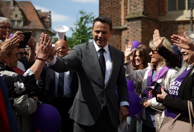 Civic Coalition presidential candidate, Warsaw Mayor Rafal Trzaskowski gives a high five to his supporter during an election meeting in Brzeg, Poland, May 14, 2025. REUTERS/Kacper Pempel/File Photo