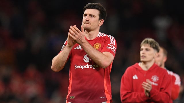 Manchester United's English defender #05 Harry Maguire applauds fans on the pitch after the UEFA Europa league quarter-final final