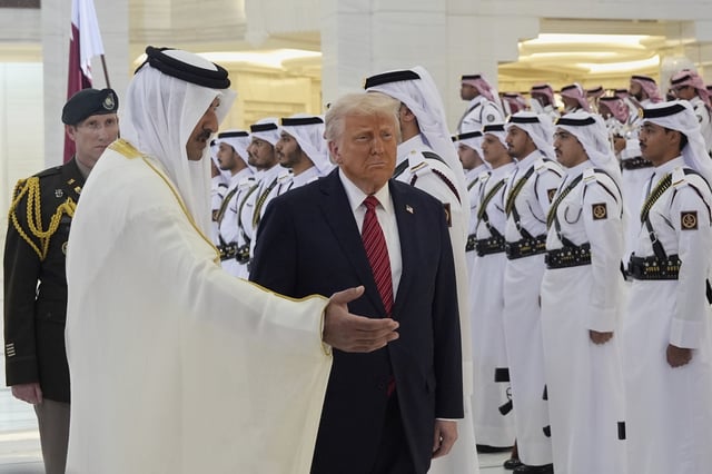 Qatar's Emir Sheikh Tamim bin Hamad Al Thani welcomes President Donald Trump during an official welcoming ceremony at the Amiri Diwan in Doha, Qatar, Wednesday, May 14, 2025. (AP Photo/Alex Brandon)