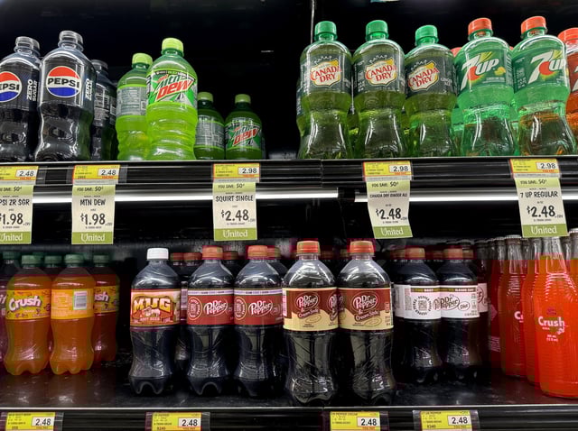 Twelve packs of Dr. Pepper soda are displayed on a shelf at a grocery store on June 03, 2024 in San Rafael, California.