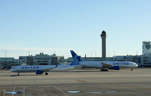 The air traffic control tower is seen from the Denver International Airport terminal, as two United flights taxi away from the gate, in Denver, Colorado, U.S., May 15, 2025.  REUTERS/Megan Varner