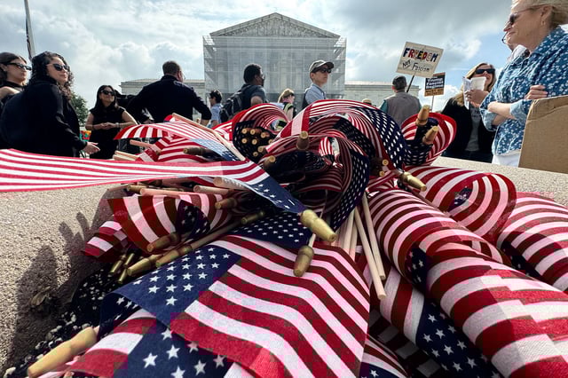American flags are seen during a protest outside the US Supreme Court over President Donald Trump's move to end birthright citizenship as the court hears arguments over the order in Washington, DC, on May 15.