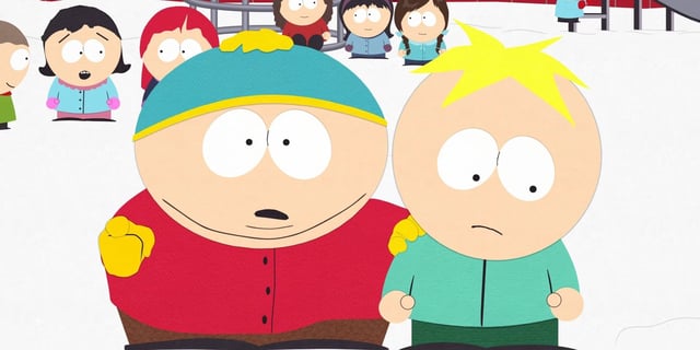 Cartman holding Butters by the shoulder as other kids look on from the background in South Park. 