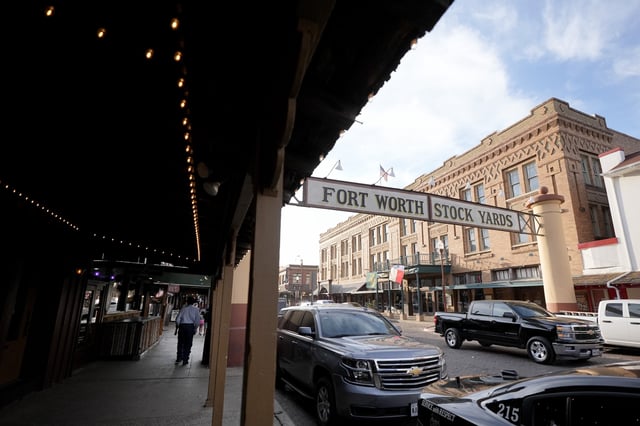 FILE - People walk down the sidewalk in the Fort Worth Stockyards, in Forth Worth, Texas, Monday, March 4, 2024. (AP Photo/Tony Gutierrez, File)