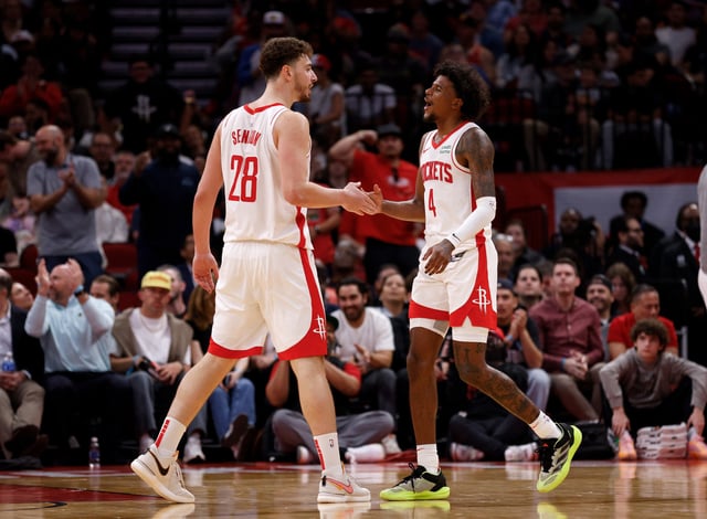 HOUSTON, TEXAS - MARCH 05: Alperen Sengun #28 of the Houston Rockets is congratulated by Jalen Green #4 in the second half against the San Antonio Spurs at Toyota Center on March 05, 2024 in Houston, Texas.