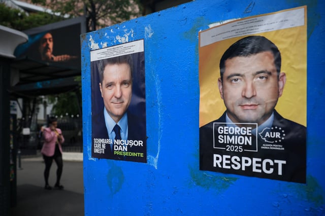 A view of electoral posters featuring presidential candidates Nicusor Dan and George Simion, ahead of the second round of the presidential elections, in Bucharest, Romania, May 16, 2025. REUTERS/Louisa Gouliamaki