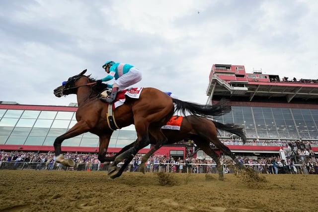 National Treasure, with jockey John Velazquez, edges out Blazing Sevens, with jockey Irad Ortiz Jr., to win the148th running of the Preakness Stakes horse race at Pimlico Race Course, on May 20, 2023, in Baltimore.