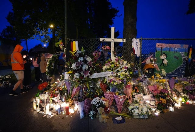 People hold a candlelight march on the Vancouver street where a vehicle-ramming attack occurred at the Filipino community's Lapu Lapu Day festival during a provincial day of mourning for the victims on Fri., May 2, 2025.