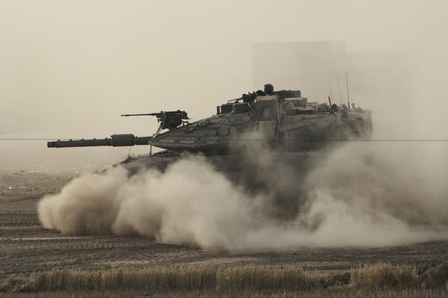 An Israeli tank moves in a staging area in southern Israel, near the border with Gaza, Friday, May 16, 2025. (AP Photo/Maya Alleruzzo)