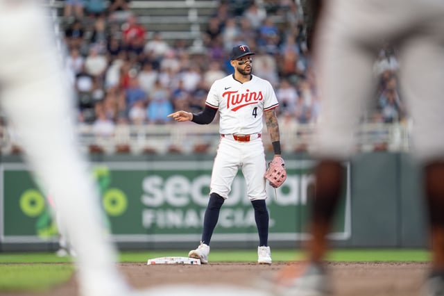 May 10, 2025; Minneapolis, Minnesota, USA; Minnesota Twins shortstop Carlos Correa (4) talks with first baseman Ty France (13) as San Francisco Giants second base Christian Koss (50) is on first base in the ninth inning at Target Field. Mandatory Credit: Matt Blewett-Imagn Images/File Photo