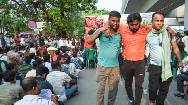 Teachers and non-teaching staff stage a sit-in protest on Friday to demand that non-tainted teachers be allowed to continue in service without any conditions. (ANI)