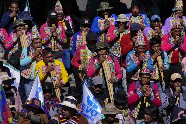 Quechua musicians play flutes in support of former President Evo Morales during a march to the Electoral Tribunal offices in El Alto, Bolivia, Friday, May 16, 2025. (AP Photo/Juan Karita)