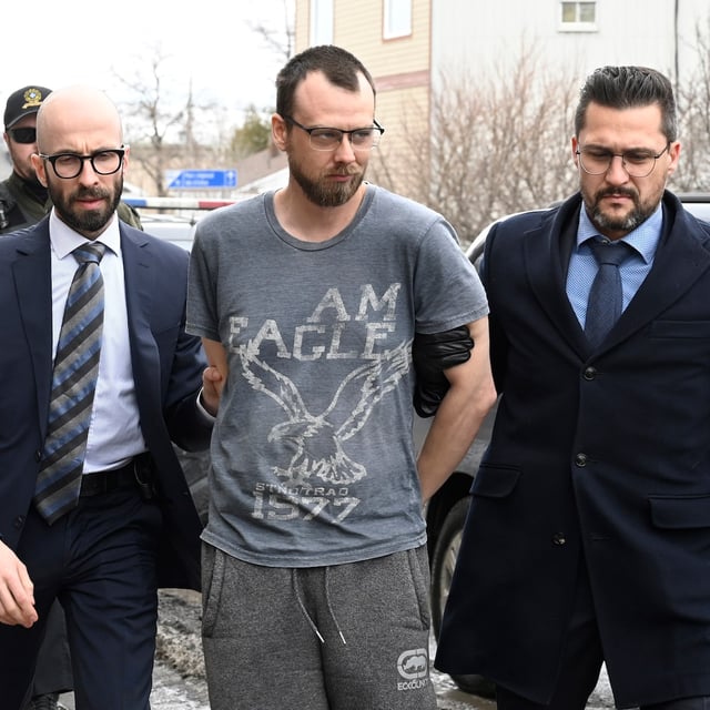 Steeve Gagnon is escorted by police into court in Amqui, Que., Tuesday, March 14, 2023. THE CANADIAN PRESS/Jacques Boissinot