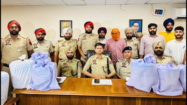 Accused in custody of the police. Tarn Taran SSP Abhimanyu Rana showing 85 kg heroin recovered from a smuggler on Friday. (HT Photo)