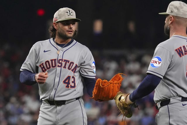 Houston Astros starting pitcher Lance McCullers Jr. (43) looks to first baseman Christian Walker, right, after the third out of the third inning of a baseball game against the Texas Rangers, Friday, May 16, 2025, in Arlington, Texas. (AP Photo/LM Otero)