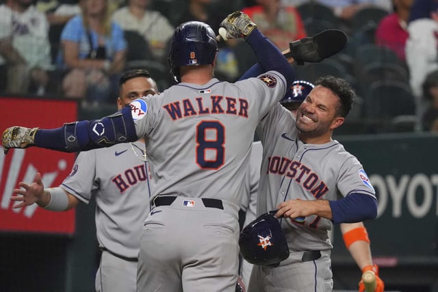 Astros first baseman Christian Walker celebrates after his three-run home run with teammate Jose Altuve during the seventh inning of Friday&#39;s win over the Rangers in Arlington.
