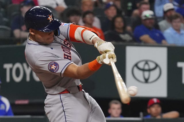 Houston Astros&#39; Cam Smith hits a single that scored teammates Jake Meyers during the seventh inning of a baseball game against the Texas Rangers, Friday, May 16, 2025, in Arlington, Texas. (AP Photo/LM Otero)