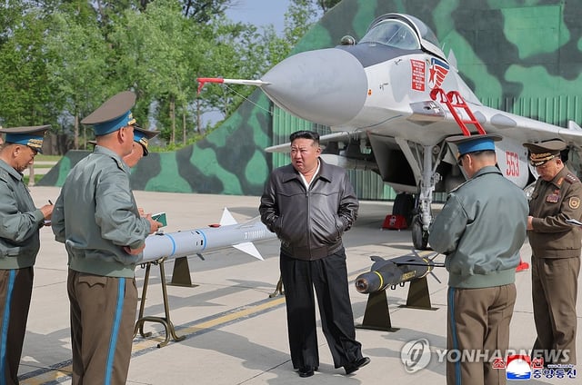 North Korean leader Kim Jong-un (C) visits a flight group under the Guards 1st Air Division of the Korean People's Army on May 15, 2025, to inspect anti-air combat and air raid drills, in this photo released by the Korean Central News Agency two days later. (For Use Only in the Republic of Korea. No Redistribution) (Yonhap)