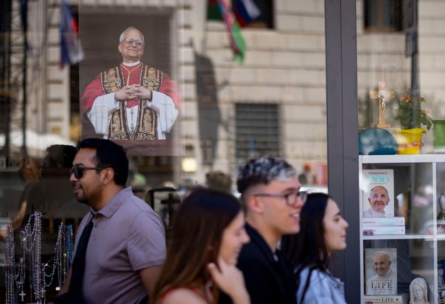 A photo of Pope Leo XIV is displayed in a shop window on May 16, 2025, near St. Peter’s Square at the Vatican. (Brian Cassella/Chicago Tribune)