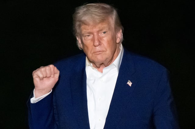 President Donald Trump raises his fist after arriving on Marine One on the South Lawn of the White House in Washington, DC, on May 16, 2025, following a trip to the Middle East.