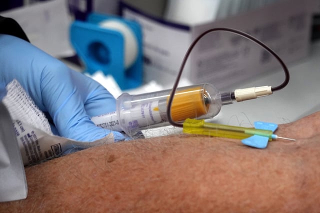 CHICAGO, ILLINOIS - DECEMBER 12: A phlebotomist draws blood for a COVID-19 antibody test at a mobile test site being run by Roseland Community Hospital on December 12, 2020 in Chicago, Illinois. The seven-day positivity rate in Illinois has been slowly receding but currently stands at 10.8%. (Photo by Scott Olson/Getty Images)
