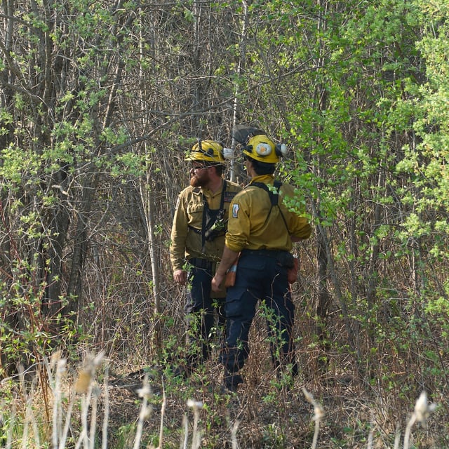 Members of the Manitoba Wildfire Program survey the land as fire crews continue to fight wildfires around Lac du Bonnet, Man., Thursday, May 15, 2025. THE CANADIAN PRESS/David Lipnowski