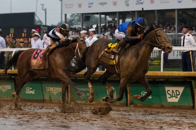 Sovereignty #18, ridden by jockey Junior Alvarado, pushes ahead of Journalism #8 to win the 151st running of the Kentucky Derby at Churchill Downs on May 03, 2025 in Louisville, Kentucky.