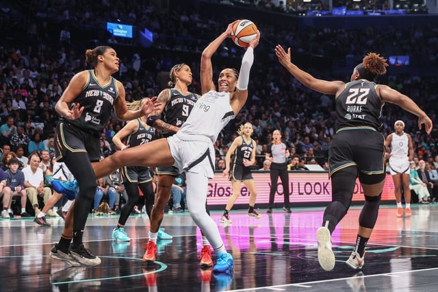 May 17, 2025; Brooklyn, New York, USA;  Las Vegas Aces center A'ja Wilson (22) grabs a rebound in front of New York Liberty center Nyara Sabally (8) in the first quarter at Barclays Center. Mandatory Credit: Wendell Cruz-Imagn Images