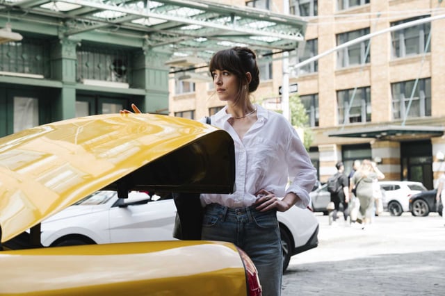 This image released by A24 shows Dakota Johnson in a scene from “Materialists.” The actress revealed she struggled financially in her early career after her father, actor Don Johnson, ended his support when she didn&#39;t go to college.