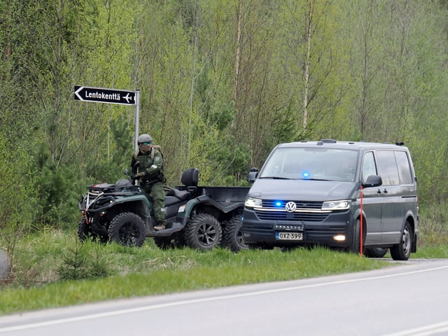 An ATV passes a police vehicle to enter the crash site near the Eura Airfield in Eura, Finland, on May 17, 2025. Lehtikuva/Petri Hakosalo via REUTERS