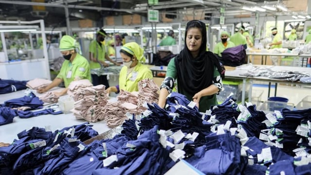 Workers make quality checks on garments produced at a factory run by the Bangladesh-based Urmi Group in Narayanganj, Bangladesh.