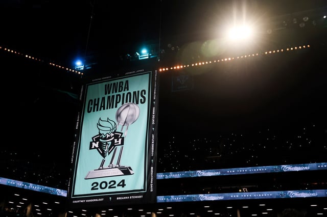 The New York Liberty 2024 WNBA Champions banner is raised before the start of a WNBA basketball game against the Las Vegas Aces, Saturday, May 17, 2025, in New York. (AP Photo/Heather Khalifa)