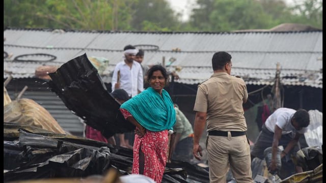 People salvage charred belongings from a site where a massive fire erupted at a slum area in Sector-52A near Ardee Mall in Gurugram on Saturday. (Parveen Kumar/Hindustan Times)