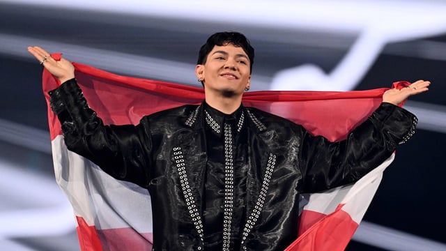 Austrian singer Johannes Pietsch, known as JJ representing Austria with the song Wasted Love parades during the flag ceremony prior to the grand final of the Eurovision Song Contest 2025, at the St. Jakobshalle arena in Basel on May 17, 2025. (Photo by Fabrice COFFRINI / AFP)