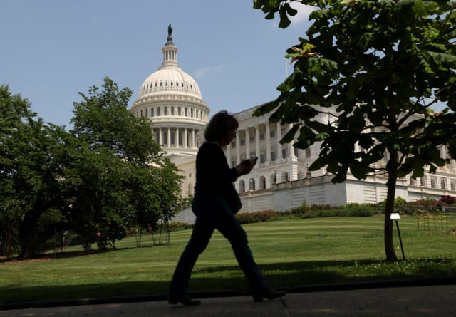 A person walks the grounds of U.S. Capitol on the day U.S. President Donald Trump's sweeping tax bill failed to clear a key procedural hurdle as hardline Republicans demanding deeper spending cuts blocked the measure in a rare political setback for the Republican president in Congress, in Washington, D.C., U.S., May 16, 2025. REUTERS/Kevin Lamarque/File Photo