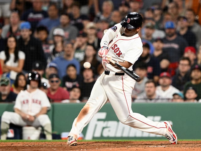 May 17, 2025; Boston, Massachusetts, USA; Boston Red Sox designated hitter Rafael Devers (11) hits a walk off home run against the Atlanta Braves during the ninth inning at Fenway Park. Brian Fluharty-Imagn Images