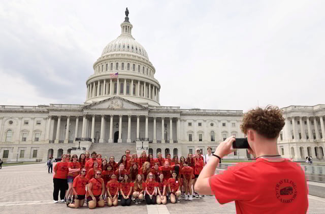 A visiting school group takes a class photo at the U.S. Capitol, on the day U.S. President Donald Trump's sweeping tax bill failed to clear a key procedural hurdle as hardline Republicans demanding deeper spending cuts blocked the measure in a rare political setback for the Republican president in Congress, in Washington, D.C., U.S., May 16, 2025. REUTERS/Kevin Lamarque