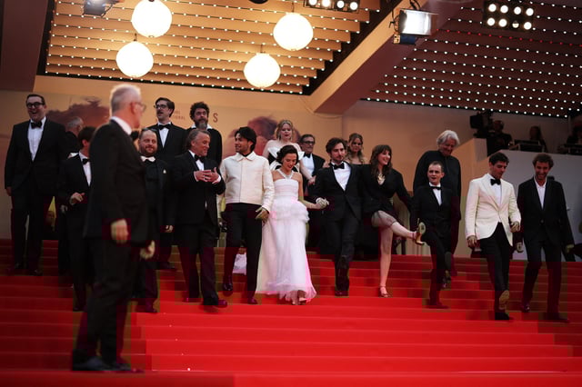 Director Richard Linklater, cast members Guillaume Marbeck and Zoey Deutch pose on the red carpet as they leave following the screening of the film "Nouvelle Vague" in competition at the 78th Cannes Film Festival in Cannes, France, May 17, 2025. REUTERS/Sarah Meyssonnier