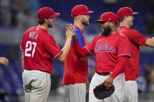 Jose Alvarado #46 of the Philadelphia Phillies high fives starting pitcher Aaron Nola #27 after defeating the Miami Marlins at loanDepot park on July 17, 2022 in Miami, Florida.