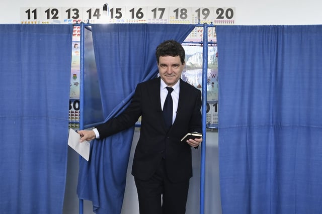 Presidential candidate Nicusor Dan exits a voting cabin before casting his vote in the second round of the country's presidential election redo in Fagaras, Romania, Sunday, May 18, 2025. (AP Photo/Eduard Vinatoru)