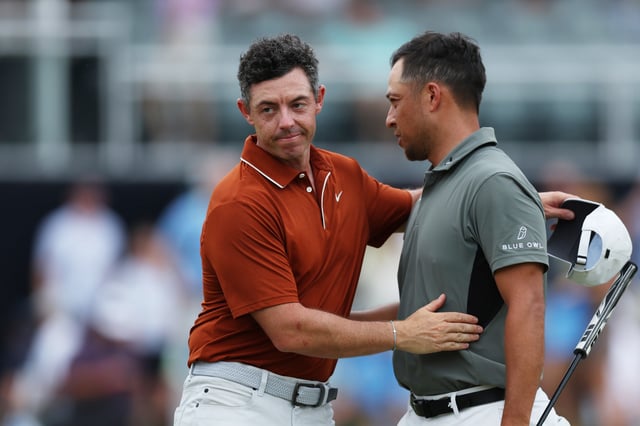 CHARLOTTE, NORTH CAROLINA - MAY 16: Rory McIlroy of Northern Ireland, left, shakes hands with Xander Schauffele of the United States on the 18th hole green after finishing the second round of the PGA Championship at Quail Hollow Country Club on May 16, 2025 in Charlotte, North Carolina.
