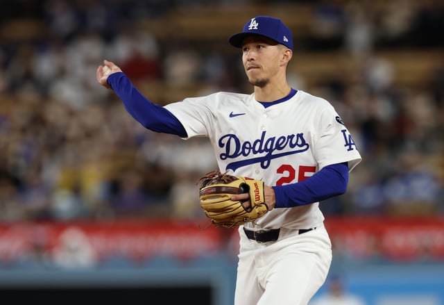 Apr 28, 2025; Los Angeles, California, USA; Los Angeles Dodgers second baseman Tommy Edman (25) throws to first for an out during the tenth inning against the Miami Marlins at Dodger Stadium. Mandatory Credit: Jason Parkhurst-Imagn Images/File Photo