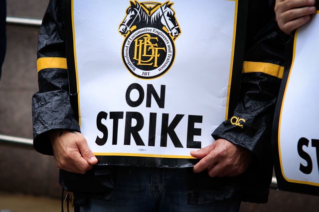 NEWARK, NEW JERSEY - MAY 16: Members of the Brotherhood of Locomotive Engineers and Trainmen BLET Union Hold posters as they take part during a Strike outside NJ Transit's Headquarters on May 16, 2025 in Newark, New Jersey.  About 450 members of the Brotherhood of Locomotive Engineers and Trainmen walked off the job after talks with NJ Transit broke down over pay. The strike, NJ Transit's first in over 40 years, has disrupted travel for roughly 350,000 commuters across New Jersey and New York City, forcing many to find alternative routes or stay home altogether. (Photo by Kena Betancur/Getty Images)